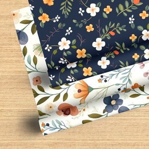 May include: Three rolls of floral patterned wrapping paper. The top roll is navy blue with white and orange flowers. The middle roll is white with orange, pink, and blue flowers. The bottom roll is white with orange and blue flowers.
