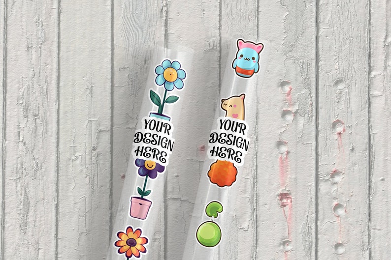 May include: Two clear plastic tubes with colorful stickers on them. The stickers include a flower, a pot, a smiley face, a llama, a green ball, and a cartoon character. The text "YOUR DESIGN HERE" is on each tube.