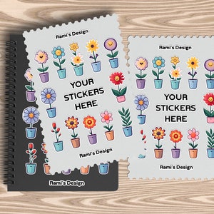 May include: Two white stickers with a colourful flower design and the text "Your Stickers Here" and "Rami's Design". The stickers are on a black spiral notebook.