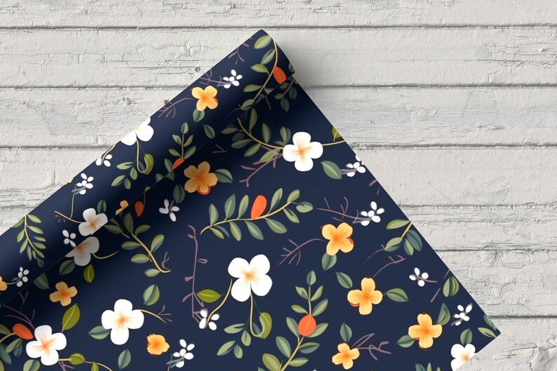 May include: A roll of blue wrapping paper with a floral pattern featuring white and yellow flowers, green leaves, and orange berries.