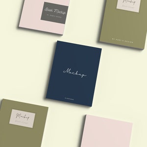 May include: Four book cover mockups in different colors and styles. The covers are all blank except for the text "Book Mockup" and "Mockup" in a handwritten font. The covers are arranged in a diagonal pattern on a light yellow background.
