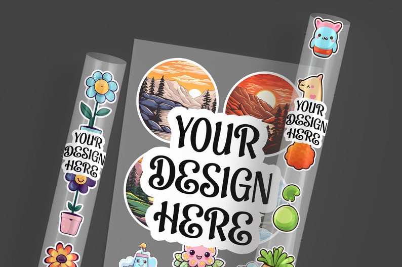 May include: A sheet of clear sticker paper with various designs. The designs include a mountain range with a sunset, a flower in a pot, a cartoon character, and a text overlay that says "YOUR DESIGN HERE".