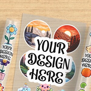 May include: A sheet of clear sticker paper with various designs. The designs include a flower, a mountain landscape, a sunset, a cartoon animal, and a text sticker that says "YOUR DESIGN HERE".