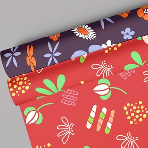 May include: Two rolls of red and purple wrapping paper with floral patterns. The red paper has white flowers, green leaves, and yellow dots. The purple paper has white flowers, orange flowers, and blue flowers.