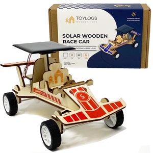 May include: A wooden solar race car kit with a black solar panel, red and white accents, and the word "SPEED". The box reads "SOLAR WOODEN RACE CAR" and "TOYLOGS WOODEN TOYS".