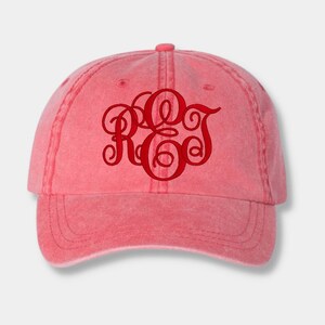 May include: A red baseball cap with a red embroidered monogram of the letters "R.O.J."