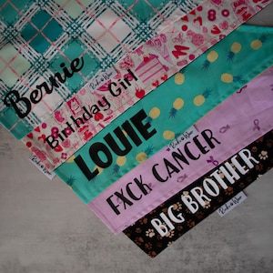 May include: A set of six fabric patches with different patterns and text. The patches are sewn together in a layered fashion, with the top layer being a green and white plaid pattern. The text on the patches reads "Bernie", "Birthday Girl", "LOUIE", "FXCK CANCER", "BIG BROTHER", and "Ruko Wear".