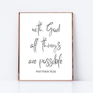 May include: A white framed print with black calligraphy that reads "with God all things are possible" and "MATTHEW 19:26".