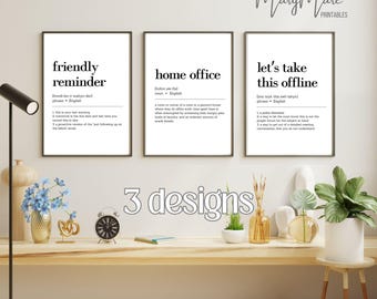 May include: Three framed wall art prints featuring dictionary-style definitions for the phrases friendly reminder, home office, and let's take this offline. Each print has black sans-serif text on a white background, presented in thin black frames.