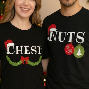 May include: Black t-shirts with Christmas-themed text and graphics. One shirt says "CHEST" with a Santa hat and a green garland with a red bow. The other shirt says "NUTS" with a Santa hat and Christmas ornament graphics.