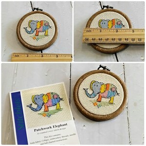 May include: A cross-stitch embroidery hoop with a patchwork elephant design. The wooden hoop is about 7.6 cm in diameter. The kit includes Aida fabric, embroidery threads, a needle, and instructions. The text reads "Patchwork Elephant".