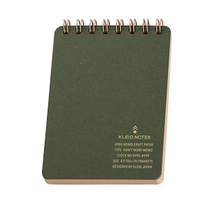 May include: A small, olive green Kleid Notes ring memo notebook. The notebook has a gold spiral binding and a kraft paper cover. Text on the cover includes "KLEID NOTES" and other details. The notebook measures approximately 4.1 x 2.9 inches.