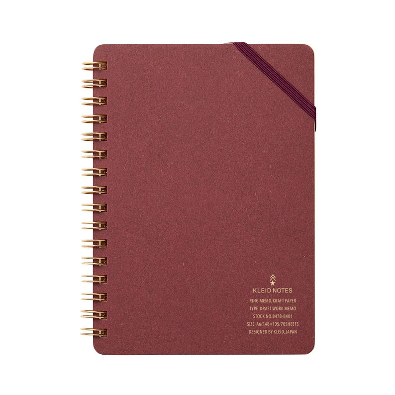 May include: A burgundy A6 ring memo notebook with gold spiral binding and a matching elastic closure. The notebook features the text "KLEID NOTES" and other details. The notebook contains 70 sheets of kraft paper.