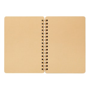 May include: An open, spiral-bound notebook with a grid pattern on the pages. The pages are a light tan color, and the spiral binding is gold. The notebook is shown against a white background.