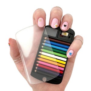 May include: A small, black pencil case with a clear plastic cover, holding a set of colorful pencils. The case also includes a pencil sharpener. The pencils are arranged in a neat row, showcasing a spectrum of colors.