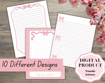 May include: Three sheets of lined stationery featuring pink bow and pearl border designs. A pink rectangular banner displays the text 10 Different Designs, and a pink scalloped label includes the text DIGITAL PRODUCT Printable Stationary.