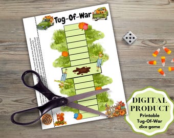 May include: A printable Tug-of-War dice game sheet featuring a central game board with green squares, a brown mud puddle, scarecrows, pumpkins, and trucks. Black scissors are placed over the paper, with a single die and candy corn nearby.