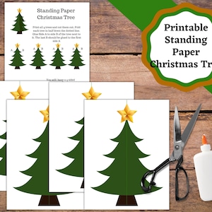 May include: Printable template for a standing paper Christmas tree. The image shows four green paper Christmas trees with gold stars on top, scissors, and glue. The instructions say to print, cut, fold, and glue the trees together.