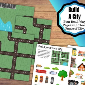 May include: A set of printed paper sheets for a children's activity. The sheets feature green backgrounds with brown roads, a blue lake, and illustrations of houses, cars, and trees. The text "Build A City" is visible.