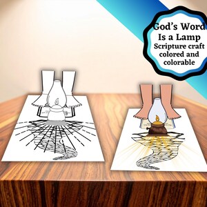 May include: Two paper crafts of a lamp with a flame, one coloured and one uncoloured, sit on a wooden surface. The coloured craft has a brown lamp and yellow light. The text "God's Word Is a Lamp Scripture craft coloured and colorable" is in the upper right.