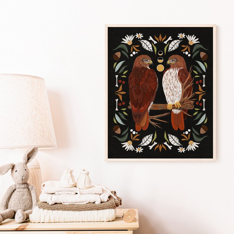 May include: A digital art print featuring two red-tailed hawks perched on a branch, surrounded by a border of stylized flowers, leaves, and acorns. The background is black with a crescent moon and stars.