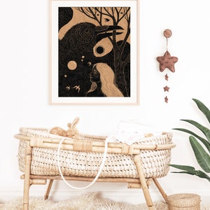 May include: A black and white illustration of a woman and a raven in a forest setting. The illustration is framed in a light wood frame and hangs on a white wall. A brown star-shaped mobile hangs from the wall above the frame.