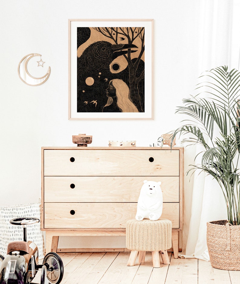 May include: A black and white illustration of a woman with long hair and a raven. The raven is perched on a branch with its wings spread. The woman is looking up at the raven. The illustration is framed and hanging on a white wall.