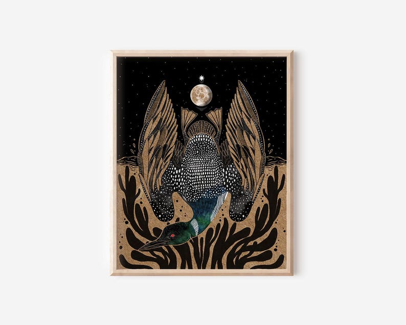 May include: A framed art print featuring a loon with black and white speckled plumage and outstretched wings. The bird is positioned above dark, abstract foliage against a black night sky with a full moon and a single bright star above.