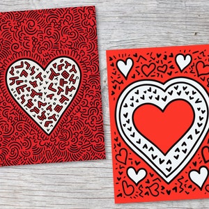 Puede incluir: Dos tarjetas de felicitaci&oacute;n rojas con dise&ntilde;os de coraz&oacute;n. Una tarjeta presenta un gran coraz&oacute;n blanco lleno de formas negras sobre un fondo rojo. La otra tarjeta tiene un coraz&oacute;n rojo con un borde blanco y corazones blancos m&aacute;s peque&ntilde;os.