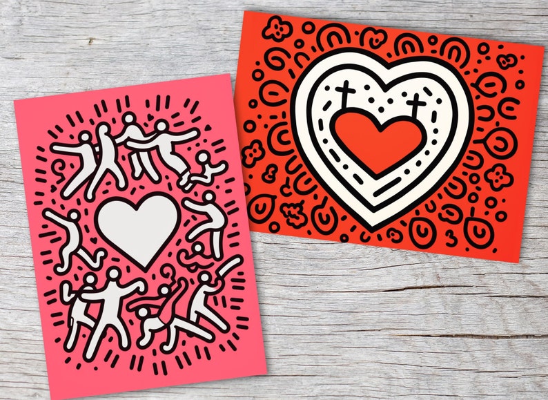 Puede incluir: Dos impresiones art&iacute;sticas con dise&ntilde;os gr&aacute;ficos llamativos. Una es rosa con figuras blancas que rodean un coraz&oacute;n blanco. La otra es roja con un dise&ntilde;o de coraz&oacute;n, contornos negros y elementos decorativos. Ambas est&aacute;n sobre una superficie de madera.