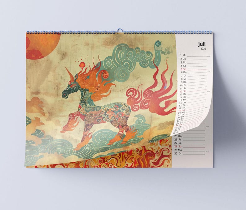 May include: A wall calendar featuring a colorful illustration of a unicorn with flowing orange and red mane and tail. The unicorn is set against a backdrop of clouds and a large orange sun. The calendar is dated July 2025.