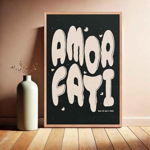 Pode incluir: Impressão em preto e branco da frase "AMOR FATI" em um estilo de fonte pingando e derretida. O texto é de cor bege claro sobre um fundo preto. A frase "love of one's fate" está escrita em uma fonte menor abaixo do texto principal.
