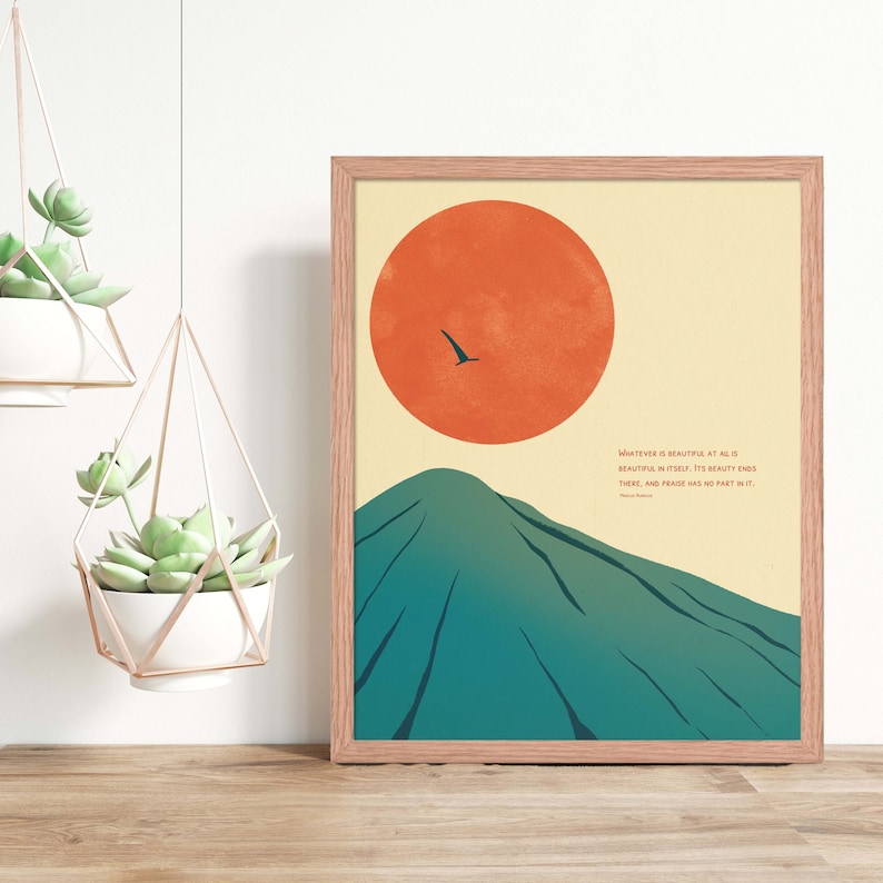 May include: A minimalist art print featuring a green mountain with a large orange sun in the background. A small black bird flies across the sky. The print includes a quote: "Whatever is beautiful at all is beautiful in itself. It's beauty ends there, and praise has no part in it." -  Ralph Waldo Emerson