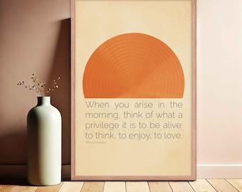May include: A beige printable wall art print with a quote by Marcus Aurelius. The quote reads "When you arise in the morning, think of what a privilege it is to be alive: to think, to enjoy, to love." The print features a large orange circle with concentric rings.