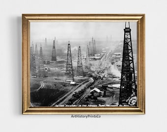 May include: Black and white framed print of an oil field with numerous derricks. The image, titled "On the Highway in the Famous Burk-Waggoner Oil Pool," shows a historical scene with a road and buildings. The print is in a gold-colored frame.