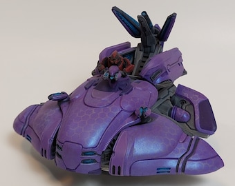 Peut inclure: Un vaisseau spatial jouet en plastique violet et bleu avec une figurine rouge assise dans le cockpit. Le vaisseau spatial a un design détaillé avec une surface texturée.