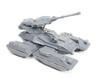 May include: A gray, futuristic-looking tank model with a large turret and multiple side compartments. The model has a detailed design, including a small figure in the driver's seat. The tank is set against a white background.