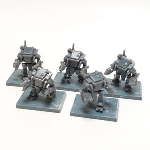 May include: Five gray miniature robot figures, each with a boxy body, articulated arms, and a small antenna. They stand on individual gray rectangular bases, suggesting a tabletop game or model kit.
