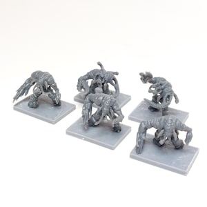 May include: Six grey plastic miniature figures of alien creatures with multiple limbs and tentacles. The figures are posed in various dynamic stances and are standing on small grey square bases.