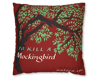 May include: Red cushion with a black silhouette of a tree with green leaves and the text "To Kill a Mockingbird" and "A Novel by Harper Lee".