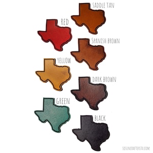 May include: Seven leather Texas-shaped keychains in different colors: saddle tan, red, Spanish brown, yellow, dark brown, green, and black.