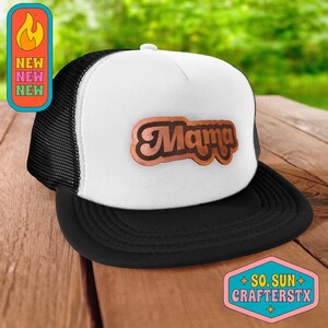 May include: White and black trucker hat with a brown leather patch that says "Mama" in a retro font.