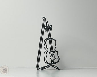 May include: A black metal sculpture of a violin on a stand. The violin is outlined in a single line, with the strings and sound hole visible.