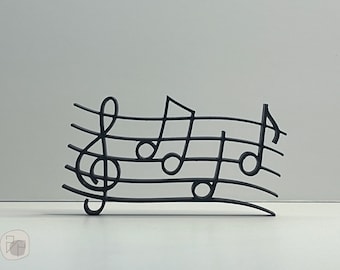 May include: Black metal music notes wall decor. The notes are arranged on a treble clef staff.
