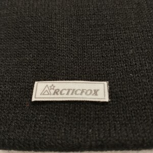 May include: Black knit beanie with a white label that says "Arctic Fox" with a star above the word "Arctic".
