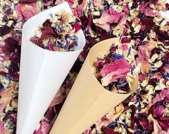 May include: Two paper cones filled with dried flower petals. The petals are a mix of pink, white, and blue.