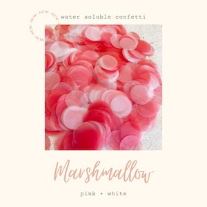 May include: Pink and white water soluble confetti. The confetti is in the shape of circles and is arranged in a pile. The text "water soluble confetti" and "marshmallow" is visible in the image.