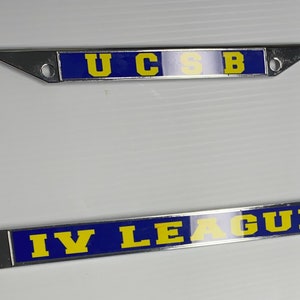 May include: A chrome license plate frame with a blue and yellow design. The top of the frame says "UCSB" in yellow letters on a blue background. The bottom of the frame says "IV LEAGUE" in yellow letters on a blue background.