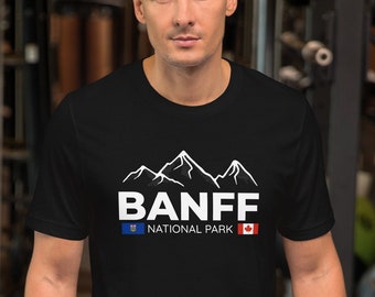 May include: Black t-shirt with a white graphic of mountains and the text "BANFF NATIONAL PARK" with the Canadian and Alberta flags.