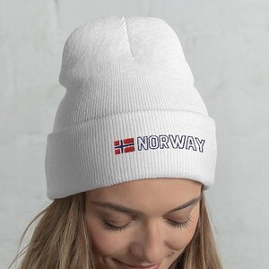 May include: White beanie with a red, white, and blue Norwegian flag and the word "NORWAY" embroidered on the front.